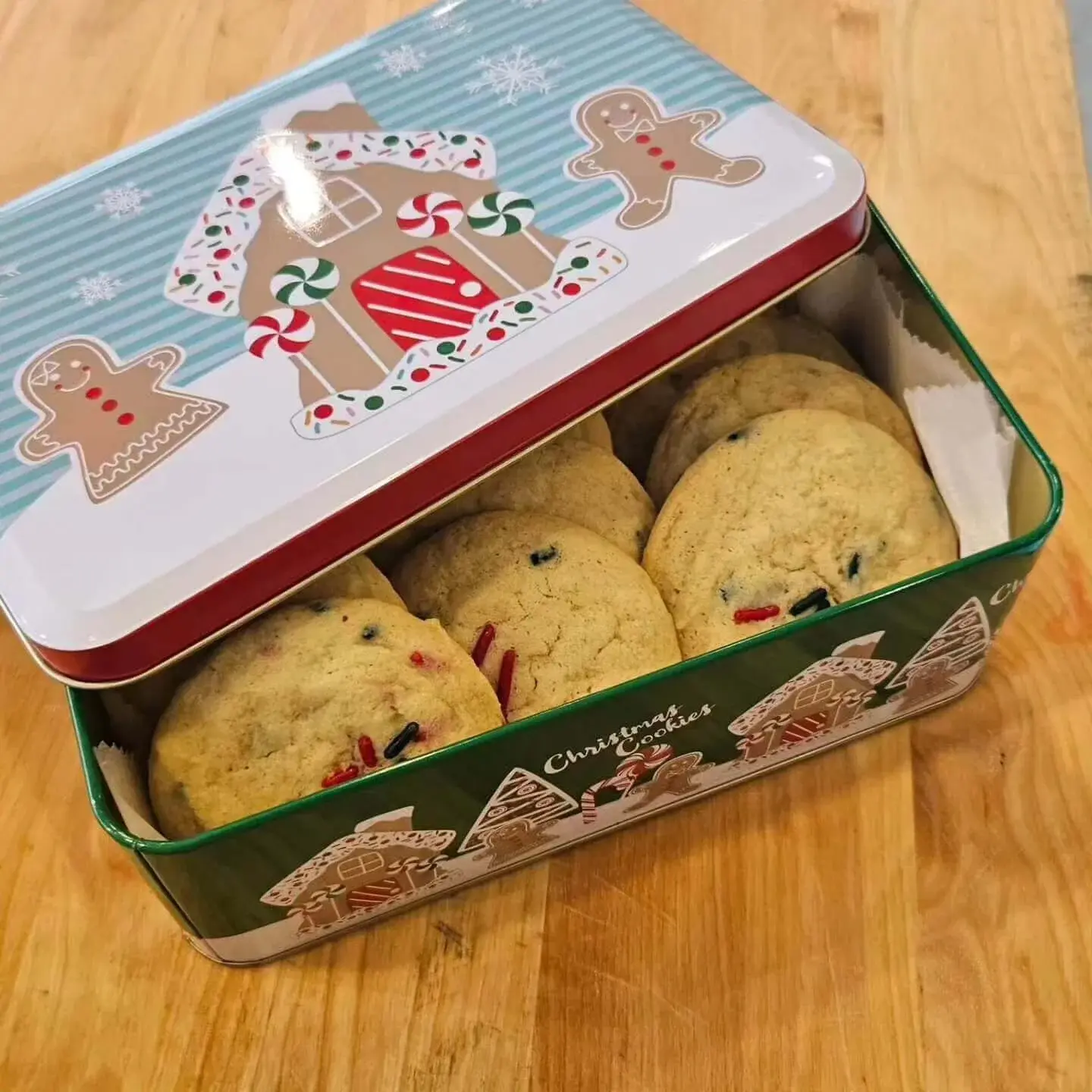 A cookie tin full of cookies.